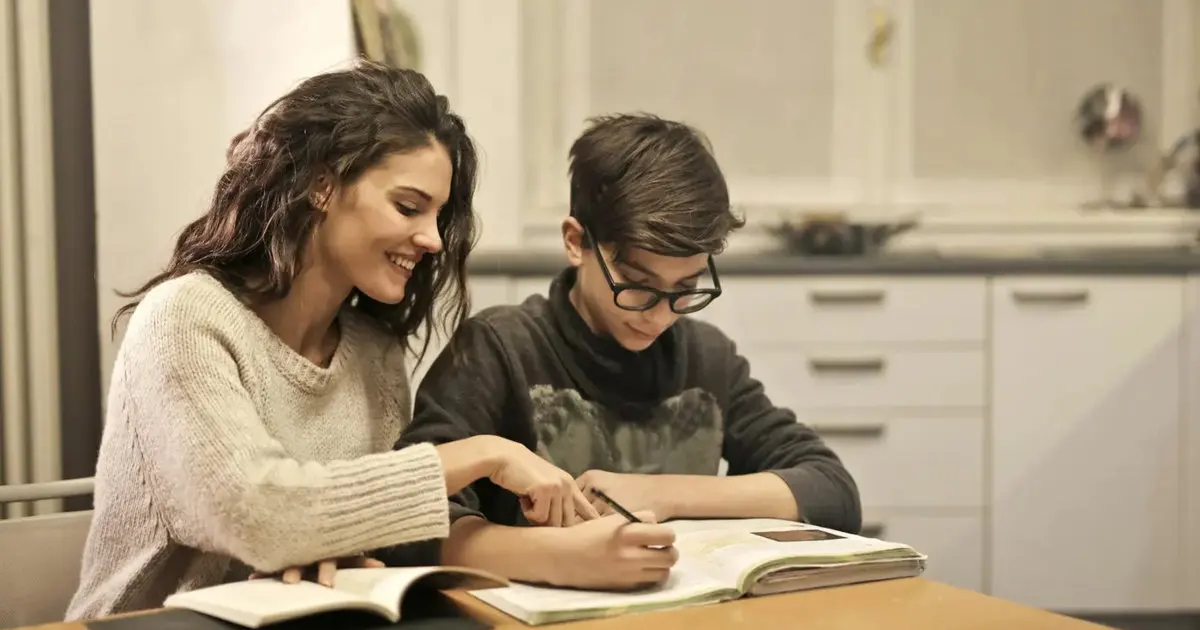 Woman teaching a young boy